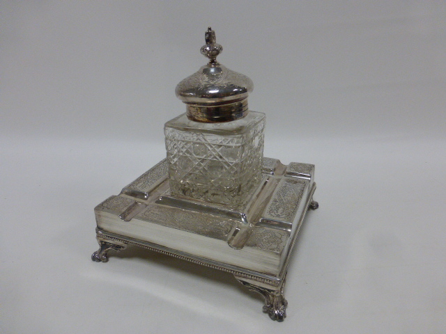 Early 20thC silver plated desk top ink well stand of square form with engraved panels,