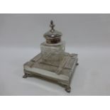 Early 20thC silver plated desk top ink well stand of square form with engraved panels,