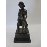 Cast Bronze of woman seated on a stool with her leg raised putting on a stocking,