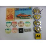 Collection of motoring items including five AA metal grill badges, six used tax discs from 1975,76,