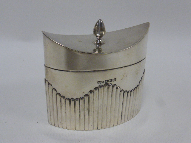 Late Victorian silver tea caddy of navette form with hinged lid and spiral finial,