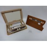 A Winsor and Newton artist box including assortment of brushes, charcoal sticks,
