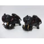 Pair of metal figures of an Elephant being attacked by two Tigers, 24cm high & 26cm long.