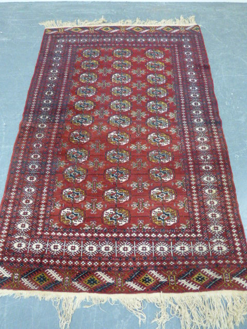 Turkmen Mauri, Turkmenistan, rug with three rows of eleven guls with a geometric border, 187x123cms.