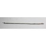 A RHODIUM FINISHED WHITE GOLD AND DIAMOND BRACELET, having fifty-one diamonds in claw setting, and