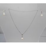 A SUITE OF RHODIUM FINISHED WHITE GOLD COLOURED METAL JEWELLERY, comprising a pendant and a pair