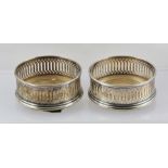 JOHN BULL LTD A PAIR OF LATE 20TH CENTURY PIERCED SILVER GALLERY BOTTLE COASTERS with turned wood