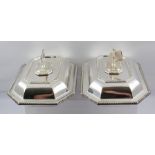 A PAIR OF SILVER PLATED CUSHION FORM TUREENS, with canted corners, gadrooned edges, the covers