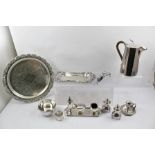 A QUANTITY OF SILVER PLATED ITEMS includes a salver, a "Walker & Hall" hot water pot, candle