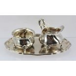 A CONTINENTAL WHITE METAL STRAWBERRY SET, comprising fluted rimmed oval tray, sugar bowl and cream