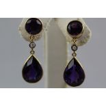 A PAIR OF 14CT GOLD AMETHYST AND DIAMOND DROP EARRINGS, each having circular amethyst with small