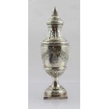 AN EARLY SILVER PEPPERETTE of urn form, decorated in Rococo style with floral and ribbon swags,