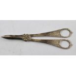 A PAIR OF WHITE METAL GRAPE SCISSORS, having chased decoration