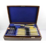 WALKER & HALL AN OAK CANTEEN OF PLATED CUTLERY, comprising a four-piece carving set, twelve table