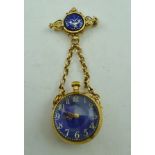 A 20TH CENTURY YELLOW METAL AND BLUE ENAMEL FOB WATCH, suspended on chains from a brooch mount,