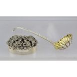 HENRY HOLLAND A SILVER SUGAR SIFTING LADLE with gilded bowl and scroll terminal handle, London 1874,