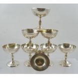 A SET OF EIGHT CONTINENTAL WHITE METAL GOBLETS, shallow bowl, raised on vase form stems with domed