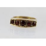 A 9CT GOLD RING SET WITH GARNETS, size O 1/2, weight 3g.