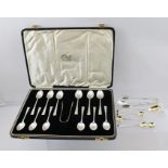 FINNIGANS LTD. A CASED SET OF TWELVE SILVER COFFEE SPOONS WITH SUGAR NIPS, London 1934, together