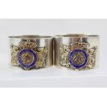 A PAIR OF RARE SILVER AND ENAMEL MASONIC SERVIETTE RINGS, set with dragon supports "West