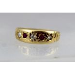 AN 18CT GOLD GYPSY STYLE RING, set with rubies and diamonds, size M