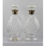 HUKIN AND HEATH A PAIR OF 20TH CENTURY CUT GLASS DECANTERS with hallmarked silver collars,