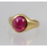 A 9CT GOLD RING set with a cabochon garnet, ring Q 1/2