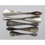 A COLLECTION OF FIVE SILVER HANDLED SHOE HORNS, includes one with inset decorative tortoiseshell