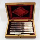 A LATE VICTORIAN SET OF SILVER COLOURED METAL DESSERT KNIVES AND FORKS FOR SIX having ornate