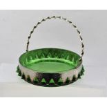 AN EARLY 20TH CENTURY SILVER PLATED FRUIT BASKET with spiral twist handle, complete with green glass