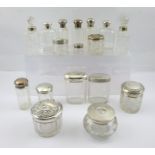 A COLLECTION OF SEVENTEEN SILVER MOUNTED CUT GLASS DRESSING TABLE JARS, together with a hair tidy