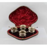 HILLIARD & THOMASON AN EDWARDIAN SET OF FOUR SILVER SALTS, with spoons (two clear glass liners),