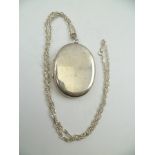 A LARGE OVAL SILVER LOCKET AND CHAIN, locket 5cm x 4cm