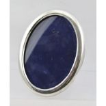 A**B** AN OVAL SILVER PHOTOGRAPH FRAME having plain surround and blue velvet easel stand, Birmingham