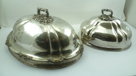 TWO OLD SHEFFIELD PLATE MEAT COVER DOMES with decoratively cast handles, the smaller one bears