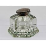 AN EARLY 20TH CENTURY GLASS INKWELL of hexagonal form with hinged silver cover. Birmingham 1930