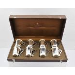 A CASE OF EIGHT SWEDISH WHITE METAL DRINKING "TOTS" with handles each engraved with an image of a