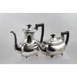 BARKER BROS LTD. A SILVER TEAPOT AND MATCHING COFFEE POT each of oblong bellied form with reeded