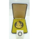 A WEDGWOOD BLACK JASPER PENDANT gilded in the Egyptian taste with a royal profile portrait wearing