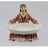 A LATE 20TH CENTURY RUSSIAN LOMONOSOV FACTORY PORCELAIN SALT, in the form of a cross legged Uzbek