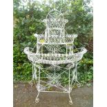 A PROBABLY VICTORIAN WHITE PAINTED WIREWORK THREE-TIER PLANT STAND of demi-lune form, having