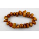 A QUANTITY OF LARGE AMBER BEADS, of irregular form . weight 288g.