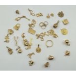 A COLLECTION OF FORTY-THREE 9CT., 10CT. AND 14CT. GOLD CHARMS, various, total weight 47g.