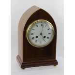 AN EDWARDIAN MAHOGANY CASED LANCET FORM MANTEL CLOCK, the white enamel dial with Roman numerals,