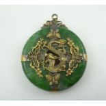 A CHINESE GREEN HARDSTONE "BI" DISC PENDANT, most probably jade, of a bright green colour with "