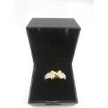 A PLATINUM AND 18CT. GOLD "KISS" RING, set with thirty diamonds, size M 1/2