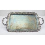 A TWO HANDLED EPNS TRAY with engraved sole, vine decorated border and shell design handles, 62cm x