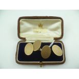 A PAIR OF OVAL 9CT. GOLD ENGINE TURNED CUFFLINKS, 12g., in a leather vendor's box