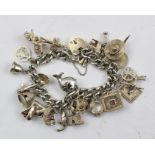 A HEAVY SILVER CHARM BRACELET, having many charms includes an opening Bee Skep