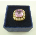 A 9CT GOLD RING set with a large Kunzite and opals, size "Q"